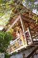 A couple of women standing on top of a wooden structure.